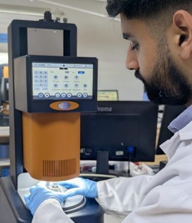 Wasif Altaf loading sample on the Core Rheometer